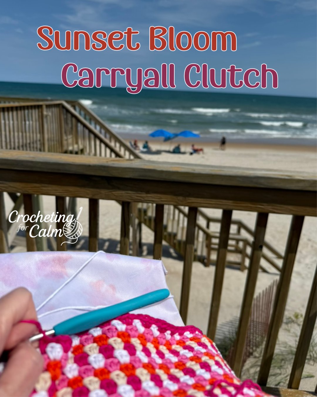 Progress shot of a pink, white, and orange crochet carryall clutch being stitched with a teal-handled hook, set against a sunny beach background with ocean waves and a wooden staircase.