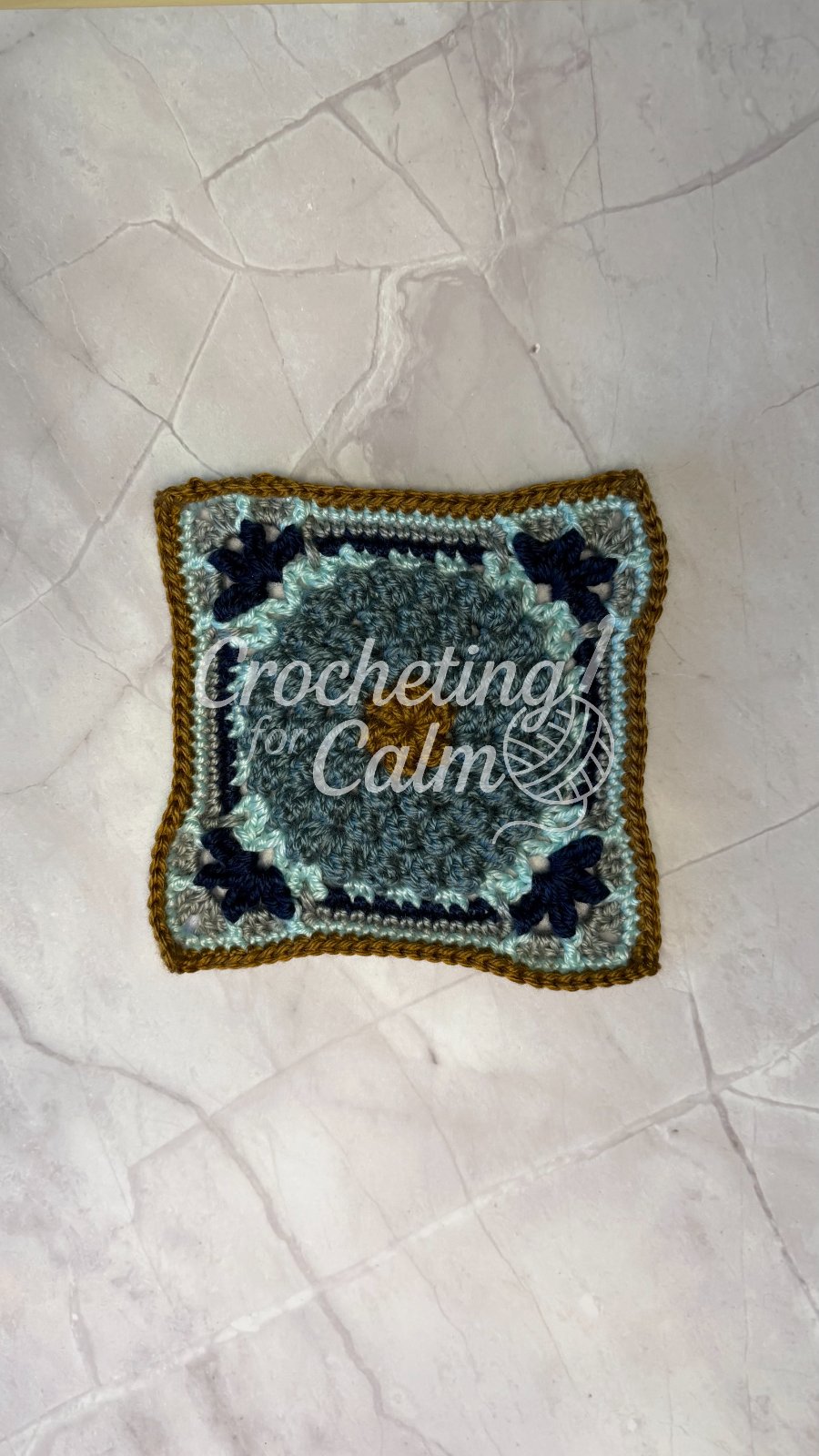 Kali Square — crochet granny square project featuring navy, gold, pale aqua and dusty teal yarns.